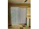 Bright living room featuring neutral-toned walls, tiled flooring, and a sliding glass door with vertical blinds at 6120 N 30Th Ave, Phoenix, AZ 85017