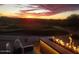 Desert backyard featuring a fire pit and golf course views at sunset at 6184 E Dusty Coyote Cir, Scottsdale, AZ 85266