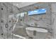 Modern bathroom features a glass shower, a tub with a view, and elegant marble tiling and fixtures at 6184 E Dusty Coyote Cir, Scottsdale, AZ 85266
