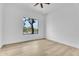 Bright, vacant bedroom with a ceiling fan and hardwood flooring at 6184 E Dusty Coyote Cir, Scottsdale, AZ 85266