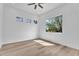 Bright, vacant bedroom with a ceiling fan and hardwood floors at 6184 E Dusty Coyote Cir, Scottsdale, AZ 85266