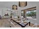 Elegant dining room with modern chandelier, hardwood floors, and plenty of natural light at 6184 E Dusty Coyote Cir, Scottsdale, AZ 85266