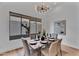 Elegant dining room featuring stylish decor, a contemporary chandelier, and natural light at 6184 E Dusty Coyote Cir, Scottsdale, AZ 85266