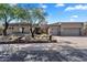 Stunning home exterior with desert landscaping, mature trees, and a spacious three-car garage at 6184 E Dusty Coyote Cir, Scottsdale, AZ 85266