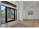 Bright foyer featuring hardwood floors, black frame windows, and high ceilings at 6184 E Dusty Coyote Cir, Scottsdale, AZ 85266