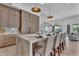 Open-concept kitchen featuring a marble island with seating, modern lighting, and wooden cabinets at 6184 E Dusty Coyote Cir, Scottsdale, AZ 85266