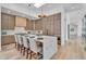 Modern kitchen with marble waterfall island, wooden cabinets, and pendant lighting at 6184 E Dusty Coyote Cir, Scottsdale, AZ 85266