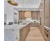 Spacious kitchen with a marble waterfall island, premium appliances, and wooden cabinetry at 6184 E Dusty Coyote Cir, Scottsdale, AZ 85266