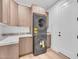 Convenient laundry room with modern stacked washer and dryer units at 6184 E Dusty Coyote Cir, Scottsdale, AZ 85266