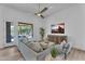 Bright living room with modern decor, ceiling fan, and a view of the outdoor pool at 6184 E Dusty Coyote Cir, Scottsdale, AZ 85266