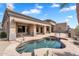 Backyard features a lagoon-style pool with a patio area and manicured landscaping at 6184 E Dusty Coyote Cir, Scottsdale, AZ 85266