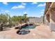 Inviting pool with blue tiled trim, an attached spa, desert landscaping, and flagstone decking at 6184 E Dusty Coyote Cir, Scottsdale, AZ 85266