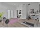 Well-lit workout room featuring a treadmill, weights, and wood flooring at 6184 E Dusty Coyote Cir, Scottsdale, AZ 85266
