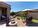 Backyard patio featuring comfortable outdoor seating, table and chairs with umbrella, and brick-paved ground at 6202 E Mckellips Rd # 183, Mesa, AZ 85215