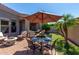 Outdoor patio featuring seating, table and chairs with umbrella, a manicured garden, and brick ground at 6202 E Mckellips Rd # 183, Mesa, AZ 85215