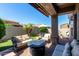 Outdoor patio featuring cozy seating, a fireplace, well-kept landscaping, and a brick-paved patio at 6202 E Mckellips Rd # 183, Mesa, AZ 85215