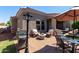 Outdoor patio featuring a grill, seating, manicured garden, table and chairs with umbrella, and brick ground at 6202 E Mckellips Rd # 183, Mesa, AZ 85215