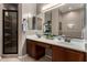 Bathroom featuring a double vanity, framed mirrors, a glass-enclosed shower, and neutral color palette at 6202 E Mckellips Rd # 183, Mesa, AZ 85215