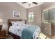 Comfortable bedroom with natural light, a ceiling fan, and a queen-sized bed with stylish bedding at 6202 E Mckellips Rd # 183, Mesa, AZ 85215