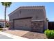 Two car garage with brick trim and paved brick driveway at 6202 E Mckellips Rd # 183, Mesa, AZ 85215