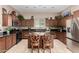 Kitchen featuring dark cabinets, granite countertops, stainless appliances, and tiled floors at 6202 E Mckellips Rd # 183, Mesa, AZ 85215