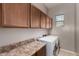 Laundry room with modern washer and dryer units, laminate counters, and upper cabinets at 6202 E Mckellips Rd # 183, Mesa, AZ 85215