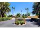 Orangaire Villas entrance featuring lush landscaping and mature palm trees on a sunny day at 6219 N 22Nd Dr, Phoenix, AZ 85015
