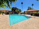 Sparkling community pool with lounge chairs, mature trees, and inviting clear blue water at 6219 N 22Nd Dr, Phoenix, AZ 85015