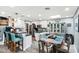 Open-concept kitchen and dining area featuring modern white cabinetry, granite countertops, and stainless steel appliances at 6219 N 22Nd Dr, Phoenix, AZ 85015