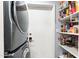 Conveniently located pantry and laundry area featuring modern appliances and ample storage space for household essentials at 6219 N 22Nd Dr, Phoenix, AZ 85015