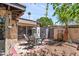 Cozy outdoor patio with a seating area, a colorful rug, and access to the house through sliding glass doors at 6219 N 22Nd Dr, Phoenix, AZ 85015