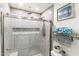 Tiled shower with glass door, niche, and modern fixtures at 6219 N 22Nd Dr, Phoenix, AZ 85015