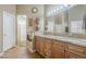Bathroom vanity featuring double sinks, granite countertops, and decorative accents at 637 E Settlers Trl, Casa Grande, AZ 85122