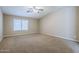 Carpeted bedroom featuring a ceiling fan and a window for natural light at 637 E Settlers Trl, Casa Grande, AZ 85122