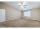 Bright bedroom featuring a ceiling fan, neutral walls, and plush carpet flooring at 637 E Settlers Trl, Casa Grande, AZ 85122