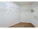 Walk-in closet with carpet flooring, wire shelving, and plenty of storage space at 637 E Settlers Trl, Casa Grande, AZ 85122
