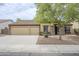 Charming single-story home with a three-car garage, stone accents, and mature landscaping at 637 E Settlers Trl, Casa Grande, AZ 85122