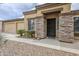 Attractive home with stone pillars accenting the entrance and a well-maintained front yard at 637 E Settlers Trl, Casa Grande, AZ 85122