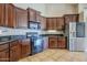 Well-equipped kitchen with granite countertops, dark cabinetry, and stainless steel refrigerator at 637 E Settlers Trl, Casa Grande, AZ 85122
