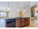 Open kitchen island overlooking additional living space with stainless steel dishwasher at 637 E Settlers Trl, Casa Grande, AZ 85122