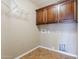 Well-lit laundry room featuring storage cabinets and wire rack at 637 E Settlers Trl, Casa Grande, AZ 85122