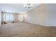 Bright living room showcasing neutral walls, carpet flooring and direct access to the front entrance at 637 E Settlers Trl, Casa Grande, AZ 85122