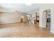 Open living space with neutral colors and tile flooring leading to the kitchen at 637 E Settlers Trl, Casa Grande, AZ 85122