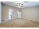 Large carpeted primary bedroom with arched entryways leading to bathroom and closet at 637 E Settlers Trl, Casa Grande, AZ 85122