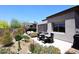 Inviting backyard oasis featuring a dining table and lush desert landscaping at 6939 E Bramble Berry Ln, Scottsdale, AZ 85266