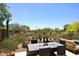 A well landscaped backyard includes an outdoor dining area and a seating area at 6939 E Bramble Berry Ln, Scottsdale, AZ 85266
