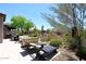 Spacious backyard with lounge chairs, dining area, and desert landscaping at 6939 E Bramble Berry Ln, Scottsdale, AZ 85266