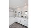 Bright bathroom featuring a double vanity with a marble countertop and white cabinetry at 6939 E Bramble Berry Ln, Scottsdale, AZ 85266