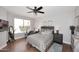 Comfortable bedroom with a ceiling fan, wood-look flooring, and natural light at 6939 E Bramble Berry Ln, Scottsdale, AZ 85266