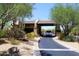 Community gate with lush desert landscaping and vehicle entering at 6939 E Bramble Berry Ln, Scottsdale, AZ 85266
